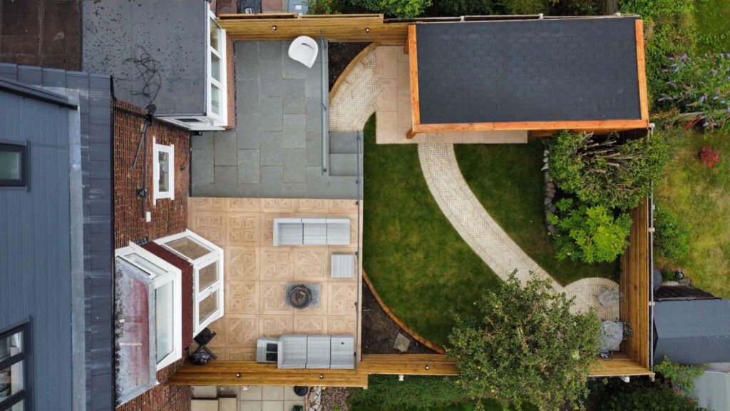 Aerial view of a garden with a curved path and garden room