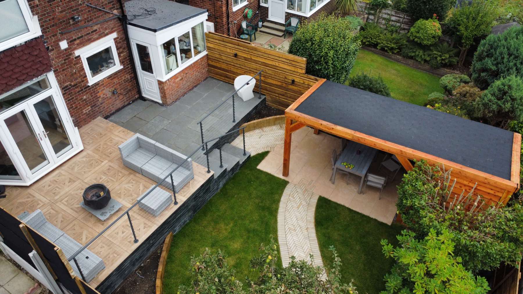Aerial view of a raised terrace, curved path and garden room