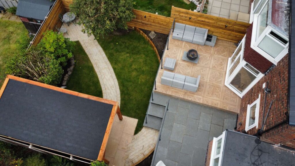Aerial view of a terrace with seating and a curved garden path