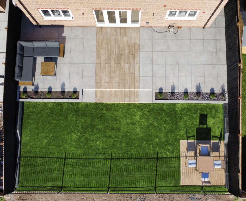 Aerial view of a finished new-build garden with porcelain, lawn and seating