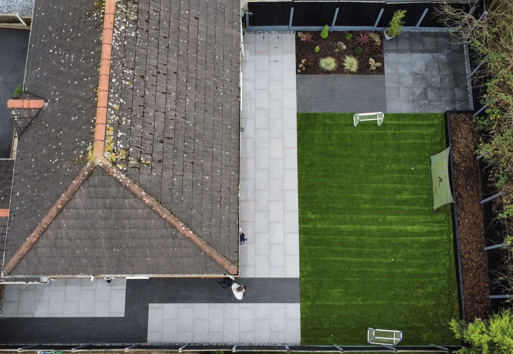 Aerial view of a porcelain patio and artificial lawn