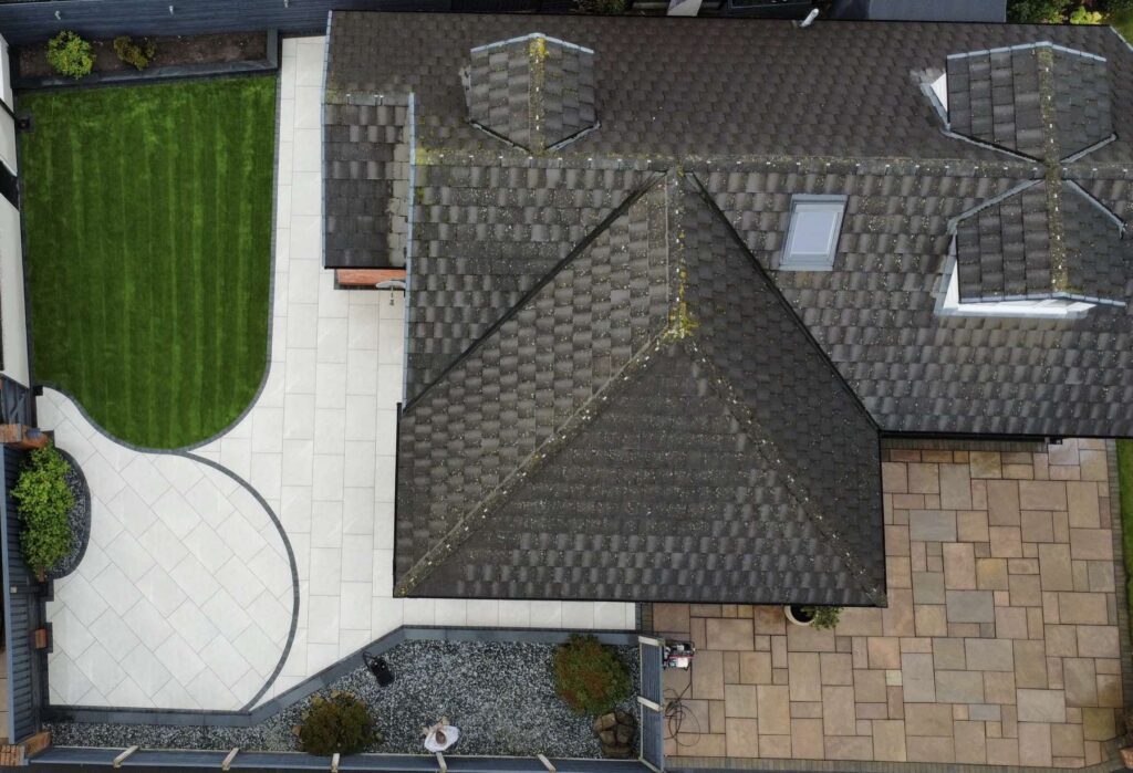 Aerial view of a porcelain patio with a curved border and lawn
