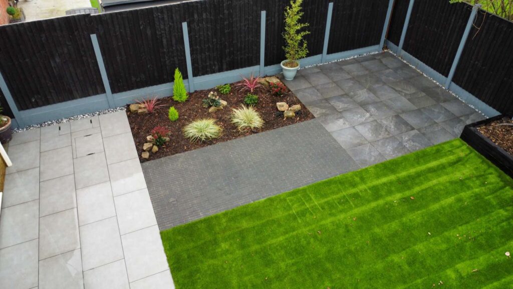 Aerial view of porcelain paving, planting bed and artificial lawn