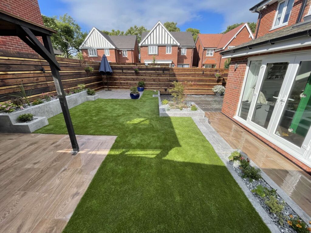 Artificial lawn, raised planters and a wood-effect patio