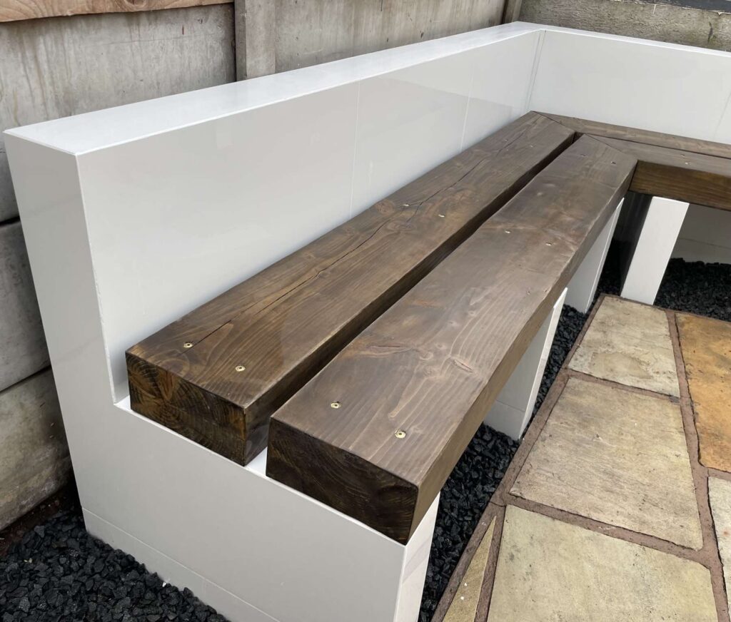 Close-up of a bespoke rendered bench with timber seat