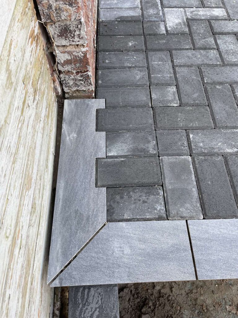 Detail of block paving meeting a porcelain edge