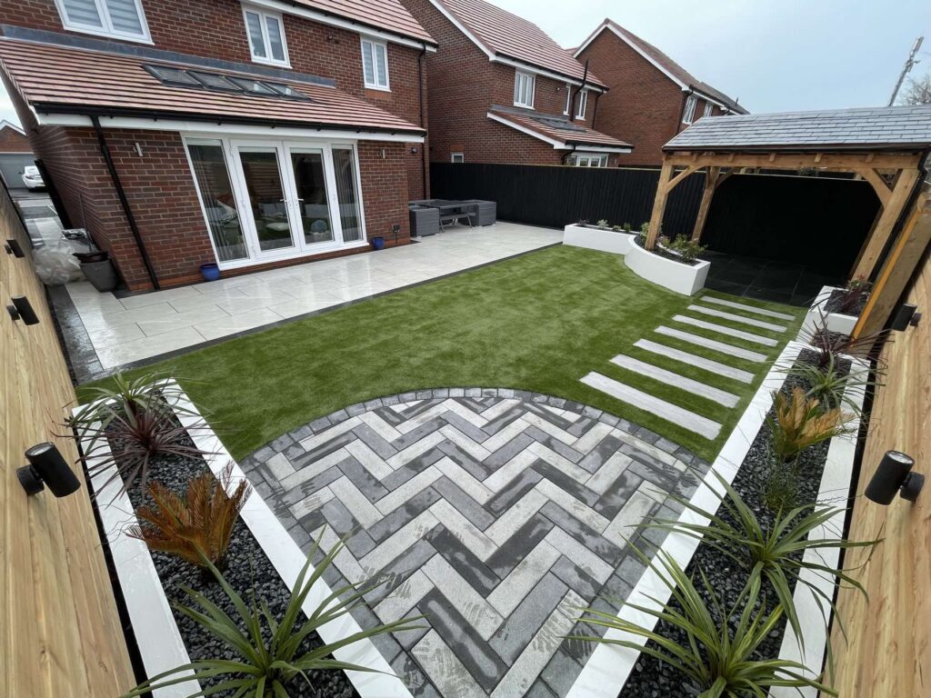 Herringbone block paving and artificial lawn with an oak pergola