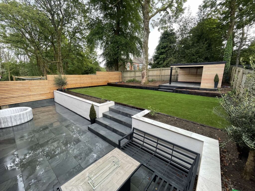 Multi-level garden with dark porcelain and a sunken seating area