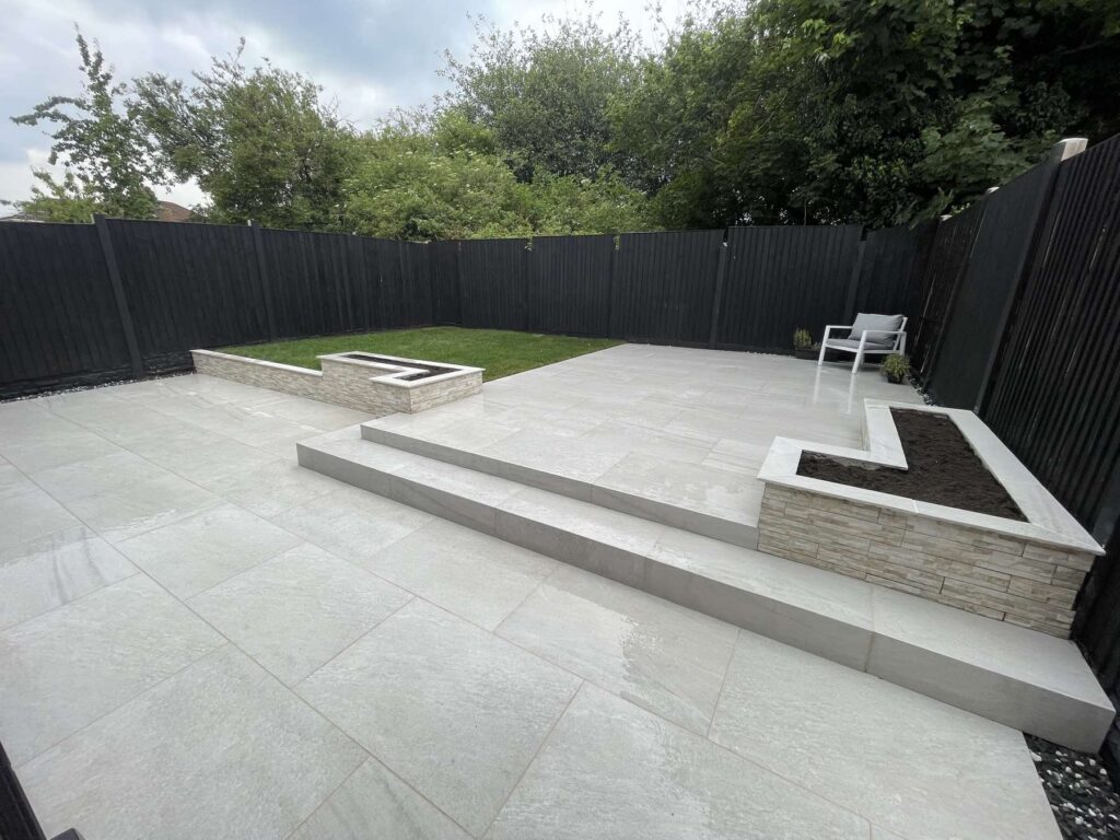 Multi-level porcelain patio with a stone-clad planter