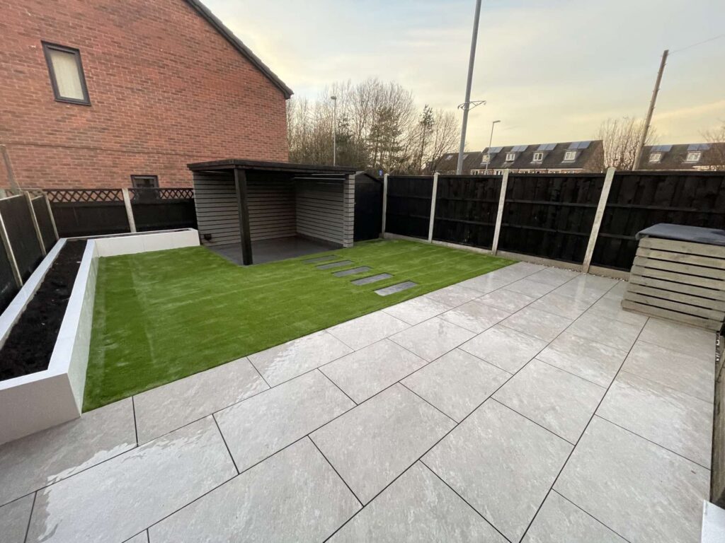 Porcelain patio and artificial grass with a garden shelter