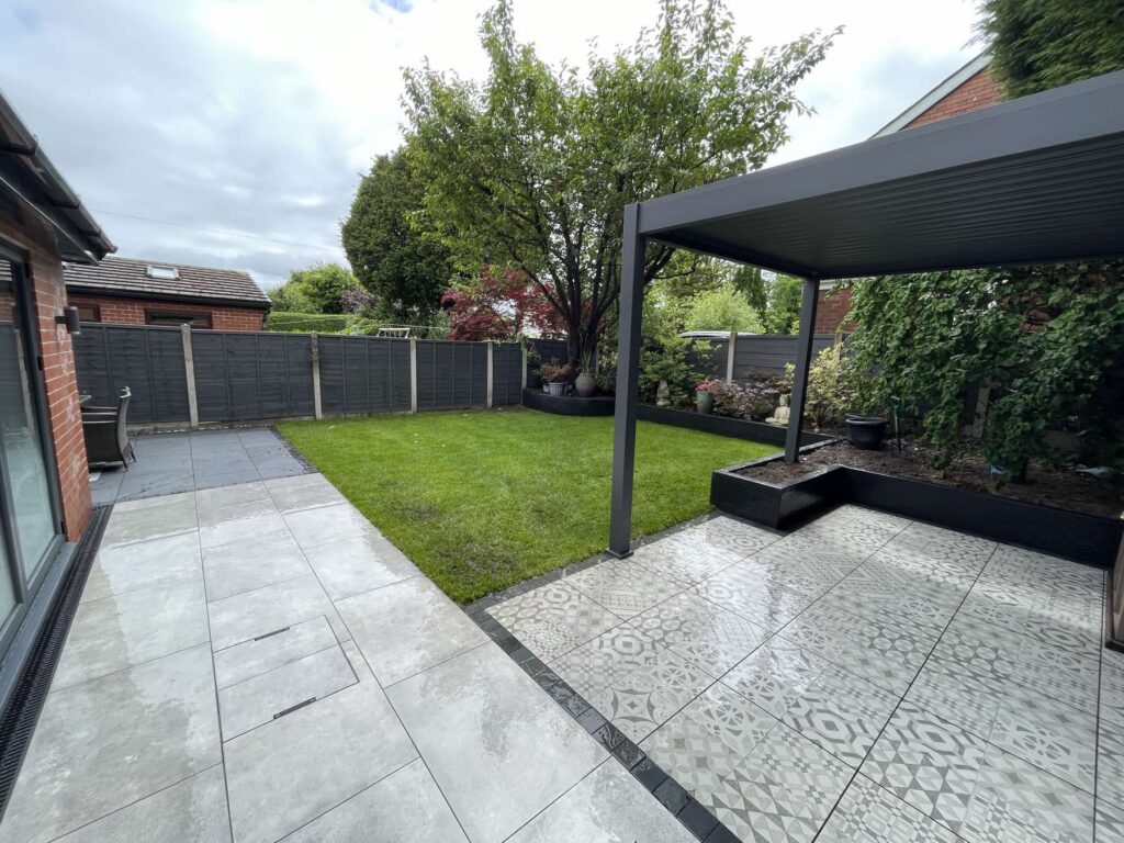 Porcelain patio with patterned feature tiles under an aluminium pergola