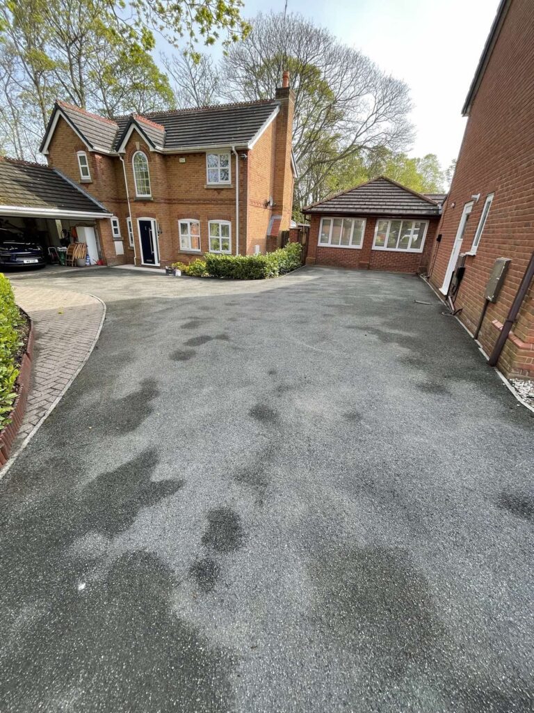 New tarmac driveway in front of a detached house