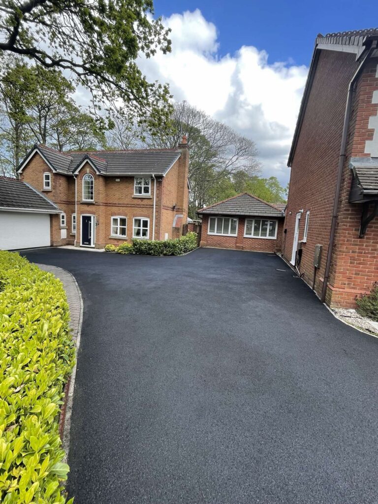 Finished tarmac driveway in front of a detached house